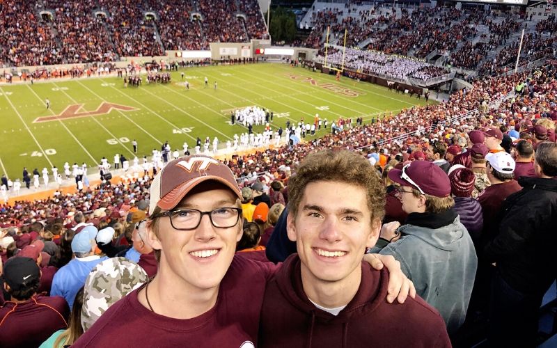 Two college guys at a Virginia Tech football game.