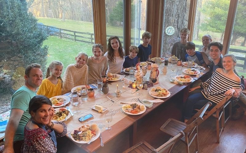 large family gathered around a big long table