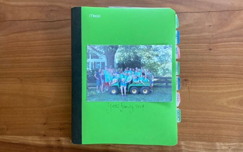 Green notebook with a family picture on the front and tabs. Susan Alexander Yates' prayer journal.