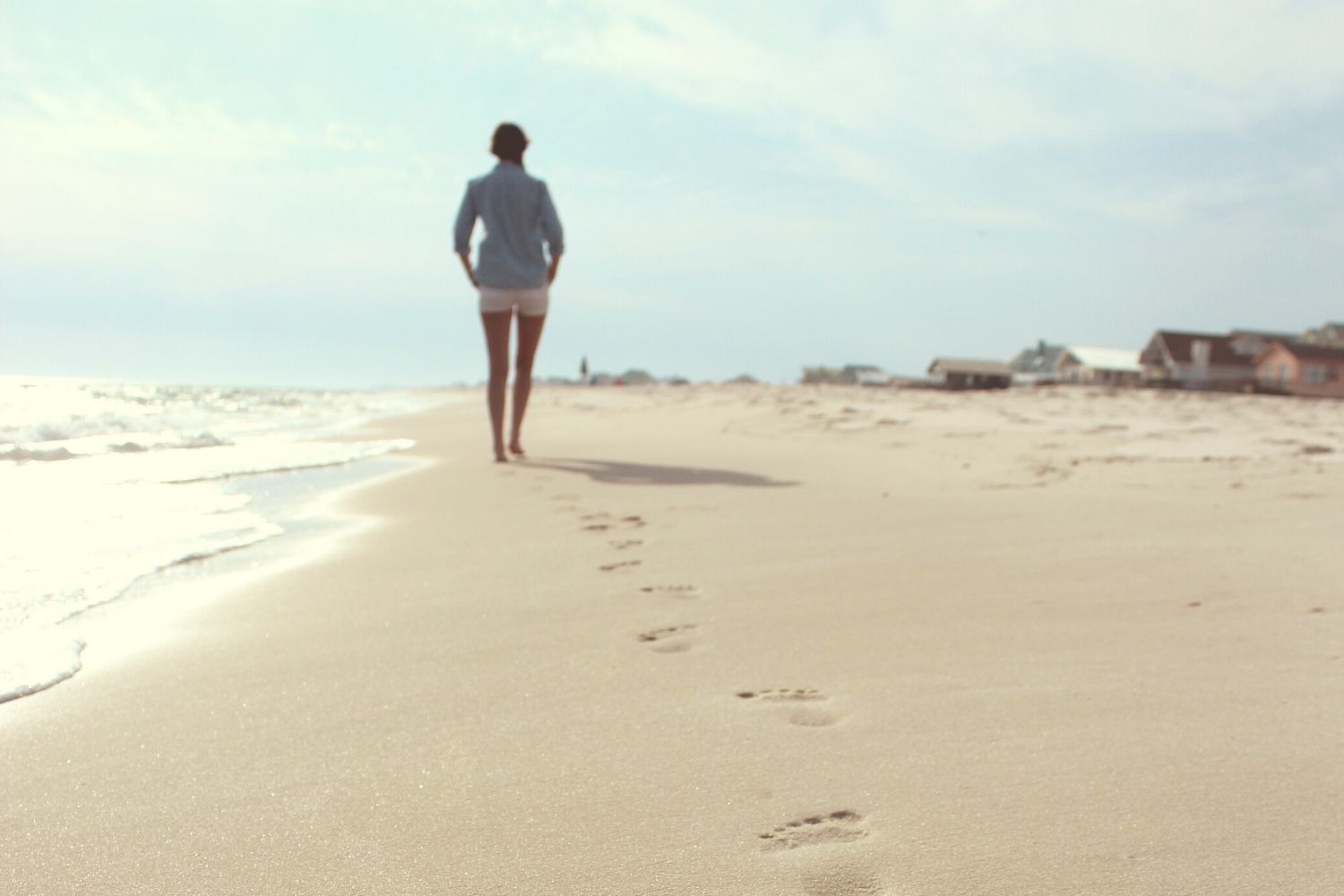 Woman walking alone on beach